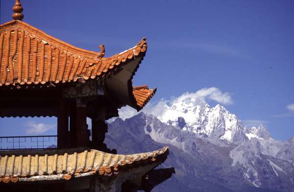 photo of China, Yunnan province, Lijiang, on top of the park around the the Hei Long Tan (Black Dragon Pond) there is this magnificent view of pavilion with the Snow Mountain of Jade Dragon (5596m) behind