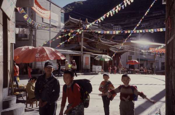 photo of China, Yunnan province, Chinese children playing on the main square of Deqin village