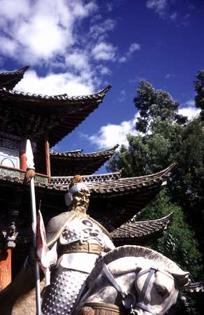 photo of China, Yunnan province, Lijiang, Chinese stone guard in front of a pavilion in the park of Hei Long Tan (Black Dragon Pond)