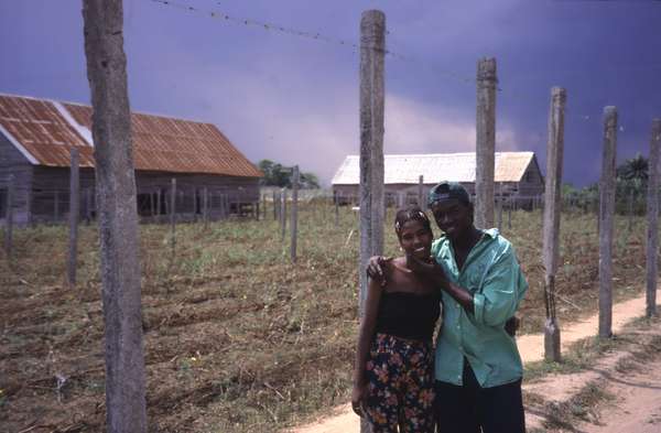 photo of West Cuba, young Cuban couple in front of tobacco field in the area of Pinar del Rio