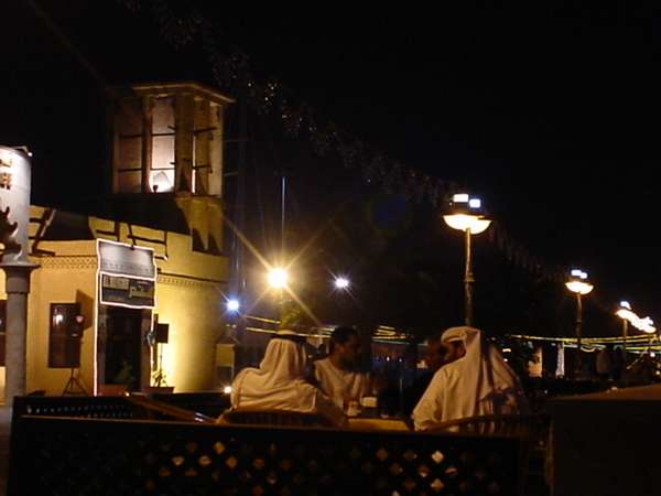 photo of United Arab Emirates, Bur Dubai, Arabs at night in front of Sheikh Saeed al-Maktoum House