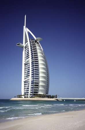 photo of United Arab Emirates, Dubai, Jumeirah Beach Resort, the "7 star" Burj Al Arab hotel has become a landmark of Dubai. This unique sail-shaped building stands on a man-made island some 280 metres offshore. It is an imposing 321 meters high.