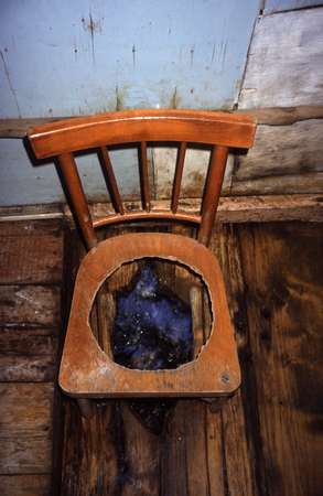 photo of Republic of Georgia, Svaneti, original toilet made of a chair above a little mountain river in the Caucasus