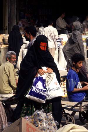 photo of Iran, Persian sea coast, around Bandar Abbas, Thursday market in Minab, woman with red burqa mask