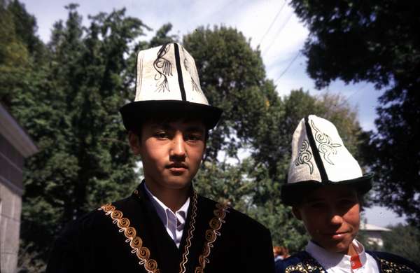 photo of Kyrgyzstan, Osh, Kyrgyz students with a kalpak, the traditional Kyrgyz hat which is made of felt and is usually white with a black rim