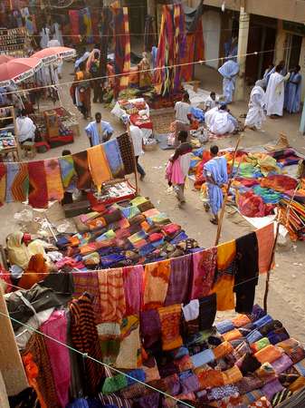 photo of Mauritania, Nouakchott, selling colorful batik fabric on the central market