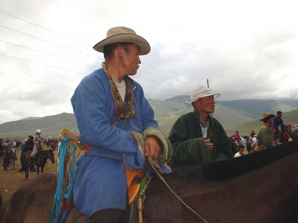 photo of Mongolia, in the fields outside Ulaan Baatar (Ulaanbaatar, Ulan Bator), three Mongolian horsemen on their horses dressed up for Naadam, the Mongolian National holiday
