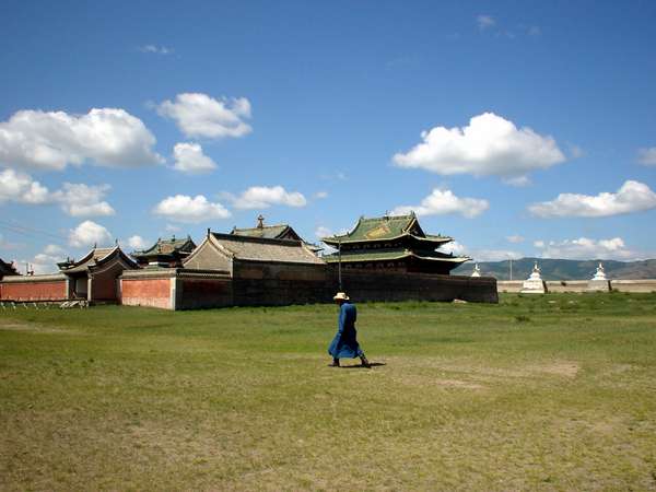 photo of Mongolia, Kharkhorin (Karakorum), Mongolian man walking in front of Erdene Zuu. This first Buddhist monastery in Mongolia was built in 1586 on the spot where Khara-Korum, the capital of the Mongolian Empire of the 13th century was