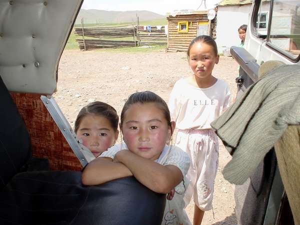 photo of Mongolia, Mongolian children looking inside a jeep