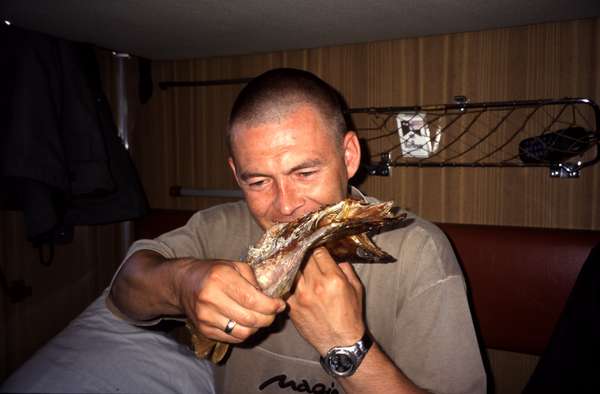 photo of Russia, along the trans siberian railway, inside a Russian railway carriage, eating dried fish bought from vendors in a tiny station along the way. The danger of Salmonella was an excellent excuse to flush every bite with huge amounts of Vodka to be sure all bacteria would be killed