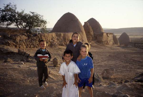 photo of Syria, around Aleppo, Syrian children in a village with beehive houses, bedouin mud homes