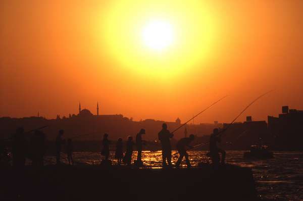 photo of Turkey, Istanbul, fishermen and sunset above the Bosphorus