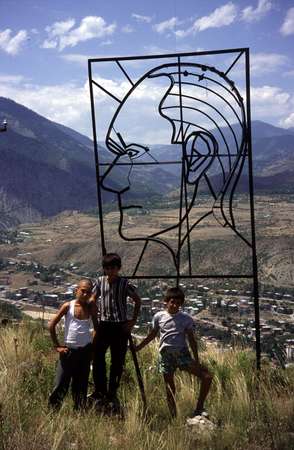 photo of Eastern Turkey, around Kars, children next to an iron profile of Mustafa Kemal Ataturk