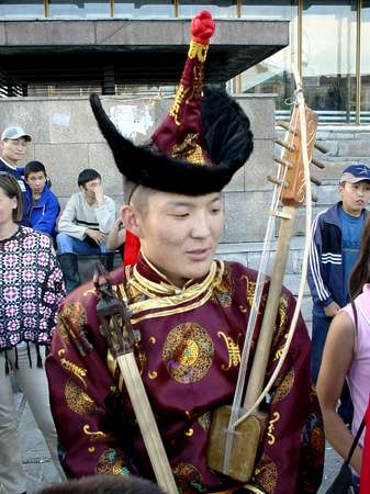 photo of Tuva, Kyzyl, theatre, Dembildei Khoomei festival 2002, Tuvan throat singing musician in traditional dress with music instrument