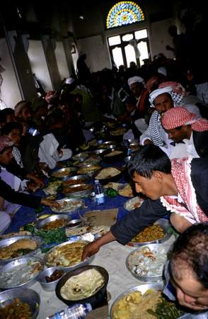 photo of Northern Yemen highlands, tiny village in the Hajar mountains, overwhelming marriage lunch carpet full of traditional Yemeni food dishes