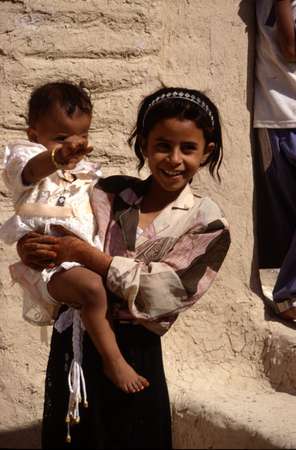 photo of Yemen, Yemeni girl and baby. It will be a big change for her when she will have to be completely covered in a sharshaf (sitaara) veil and Hijab, the whole black covering including the head scarf and veil