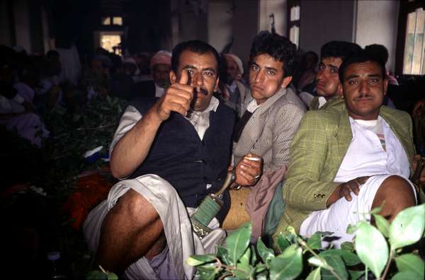 photo of Yemen, chewing extreme amounts of stimulating qat (khat, kat) leaves on a wedding party afternoon; remark the swollen cheeks