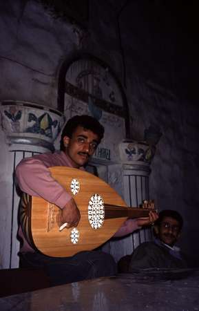 photo of Yeman, Sanaa, Yemeni man playing lute, the main instrument of traditional music in Yemen