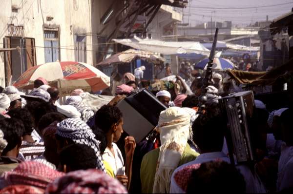 photo of Yemen, Bayt al Faqih friday souq, the electronics part of the market, people are carrying old TV's and radio's on their shoulders through the crowd, shouting the price, in the hope to sell soon and get out of the burning hot sun
