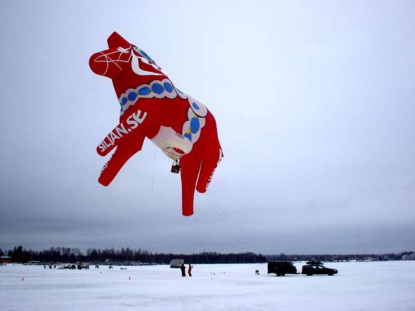 photo of Sweden, Mora, Dalarna Häst (horse) balloon attached to a Volvo on a frozen lake during Vasaloppet in Mora, the red and white little wooden horse is one of the most 'typical' (and useless) presents tourists take home from Sweden