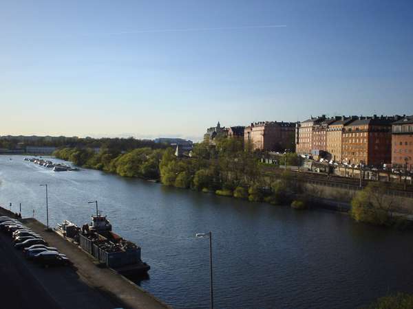 photo of Sweden, Stockholm, view on the water and the colorful houses of Vasastan, as seen from the bridge connecting Vasastan to Kungsholmen