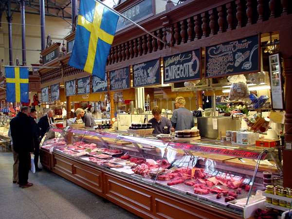 photo of Sweden, Stockholm, Östermalm market hall, selling raindeer, deer and other game under the Swedish flag in this old fashioned covered market in the upmarket quarter of Östermalm