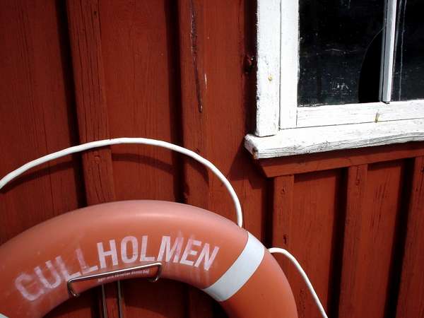 photo of Sweden, West Coast, Göteborg (Gothenburg) archipelago, detail of a red house and buoy on the island of Gullholmen
