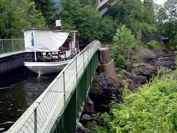 photo of Sweden, Dalsland, the aqueduct in Håverud, dating from 1868, a boat passes over this water bridge in the canal after having survived two high and rocky locks