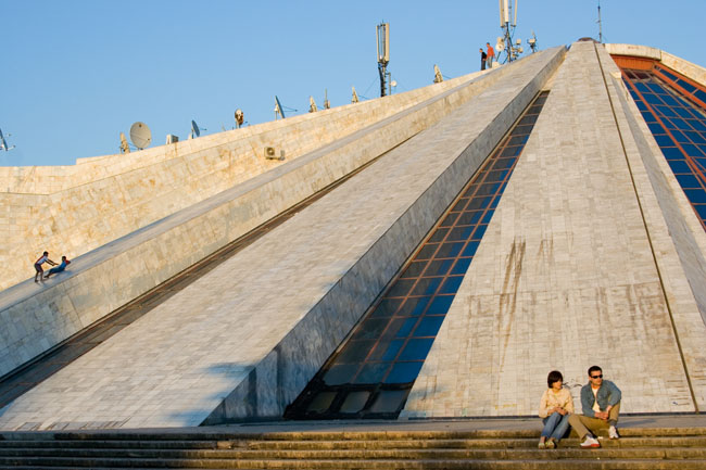 TIRANA, photo of kids children sliding from the PYRAMID, a communist building, the former Enver Hoxha museum. 