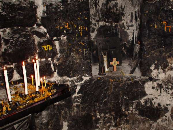 photo of Central Armenia, Ararat region, Khor Virap monastery church, candles and a cross in the underground chamber where St. Gregory the Illuminator was imprisoned