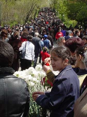 photo of Central Armenia, Yerevan, selling flowers on Genocide Day, the 24th of April, in the background you can see the masses going up to the Genocide monument