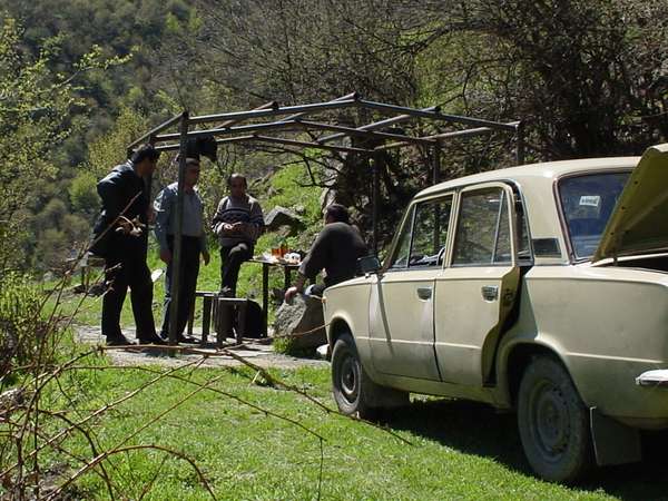 photo of North Armenia, around Alaverdi, villagers having a small party with barbecued shashlik, bread, vodka and fresh spring water