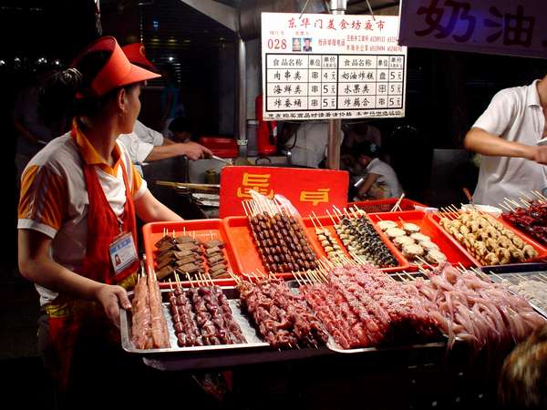 photo of China, Beijing (Peking, Pekin), Dong Hua Men Night Market, next Wangfujing shopping centre, the perfect place to taste a street snack of roasted snake, scorpion, hearts, brains, stomach, sparrows, crickets and silkworm grubs