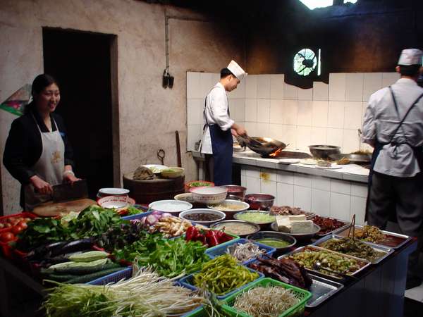 photo of China, the food served in road restaurants is often delicious, here a view of the kitchen full of fresh vegetables of a snack shack along a provincial road in Yunnan