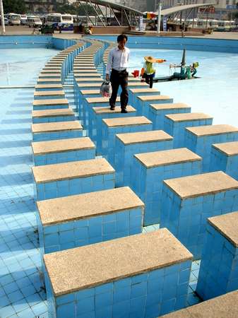 photo of China, Guanxi province, walking on a dried out fountain in Guiyang