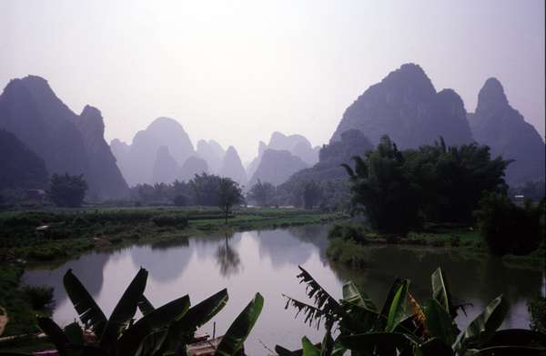 photo of China, Guanxi Region, landscape around Yangshuo and Guilin. The limestone, weathered and eroded by water, became today's fantastic stone forests, peaks, underground streams and caves, thus giving unique features to Guilin's scenery