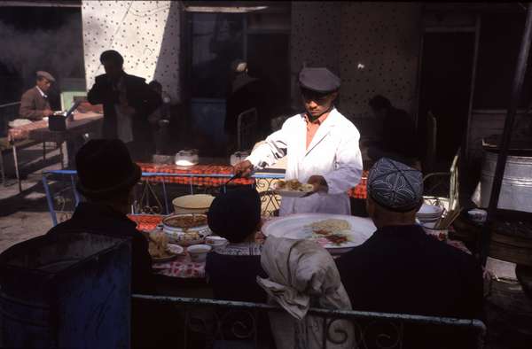 photo of China, Xinjiang province (East Turkistan), Kashi, serving Uygur food at a street snack on the Kashgar Sunday market