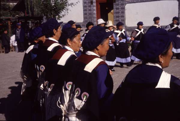 photo of China, Yunnan province, Chinese woman in traditional clothes dancing folk dances in the beautiful old Chinese village of Lijiang