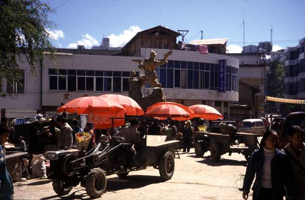 photo of China, Yunnan province, Chinese farmers tractors on the market of the rural village Weixi