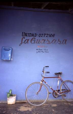 photo of Cuba, Chinese bike in front of a blue shop. In 1989, with the breakup of the Soviet Union, Cuba was hit with an huge energy crisis. Suddenly their energy supply was cut by over 50%. Fidel responded by importing over a million Chinese bicycles and establishing six bicycle factories