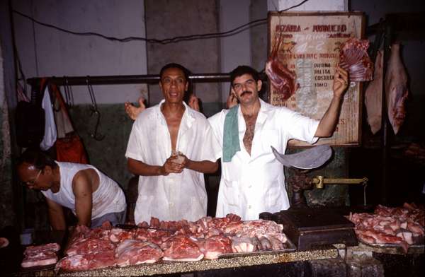 photo of Cuba, Cuban butchers selling big chunks of meat on a covered market in Havana
