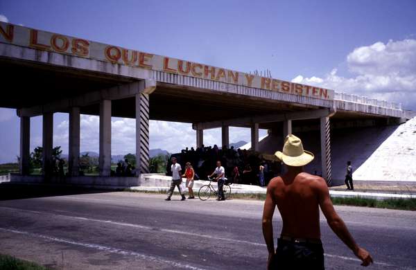 photo of Cuba, Cuban farmer crossing the highway which leaves Havana to the West. Allthough there are 3 lanes in each direction, due to the economical crisis and communist restrictions on private ownership, only one vehicle every half an hour passes by