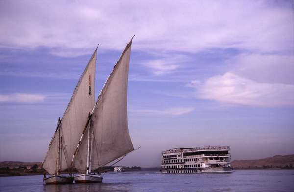 photo of Egypt, around Luxor, two felucca and a cruise boat on the Nile