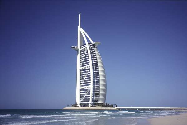 photo of United Arab Emirates, Dubai, Jumeirah Beach Resort, the "7 star" Burj Al Arab hotel has become a landmark of Dubai. This unique sail-shaped building stands on a man-made island some 280 metres offshore. It is an imposing 321 meters high.