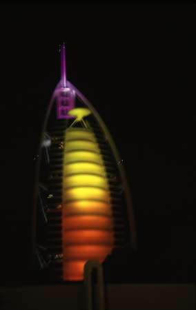 photo of United Arab Emirates, Dubai, Jumeirah Beach Resort, changing colors of the Burj Al Arab hotel at night