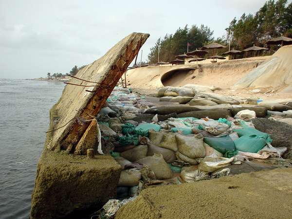 photo of Gambia, Atlantic coast, Kotu beach, a concrete wall and sandbags on the beaches of the luxurious Senegambia and Kairaba hotels. The continued excavation of sand for construction has led to serious problems with coastal erosion