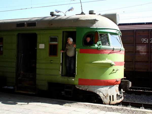 photo of Republic of Georgia, green red Georgian train leaving the train station of Gori