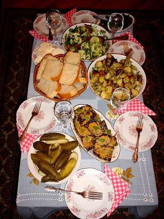 photo of Republic of Georgia, a table full of delicious Georgian dishes; the Georgian kitchen is unique and uses lots of fresh spices. In Russia it has the same status as the French kitchen in Europe