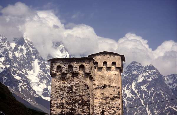 photo of Republic of Georgia, Svaneti, medieval stone towers in the village of Ushguli, in the background the snowy peak of the Mount Shkhara (5200 m)