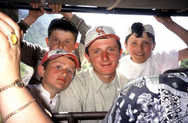 photo of Republic of Georgia, Svaneti kids looking through the back of a UAZ jeep